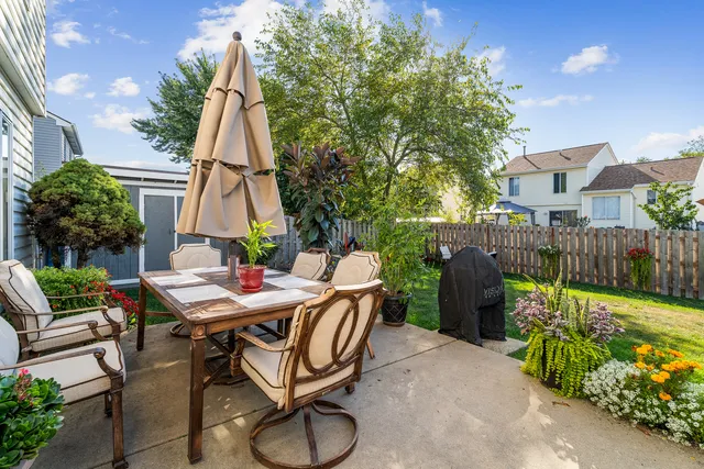 a view of backyard with outdoor seating a patio and plants