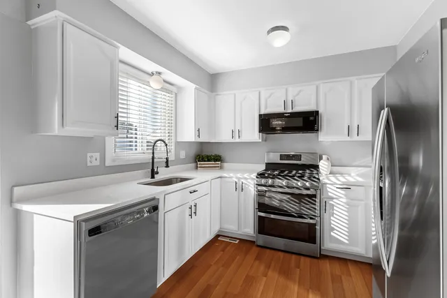 a kitchen with a sink stove and refrigerator