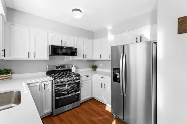 a kitchen with stainless steel appliances a refrigerator stove and sink