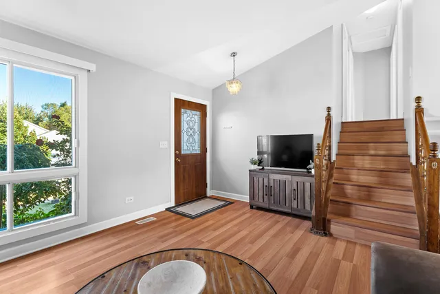 a bedroom with furniture and a flat screen tv