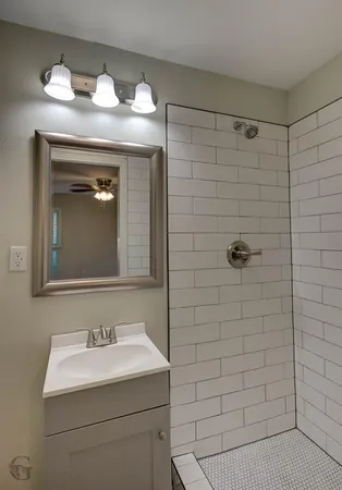 a bathroom with a sink a toilet and mirror