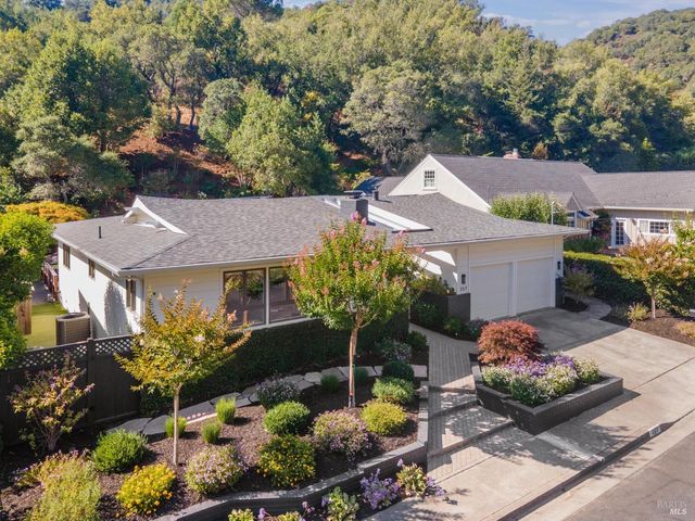a front view of house with yard and green space