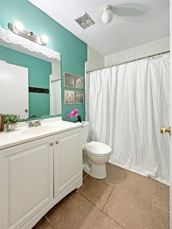 16230 Katherine Lane Channelview, TX 77530 - Photo 12 of 19 features a fresh, light design with a teal accent wall, white cabinetry, and tiled floor.