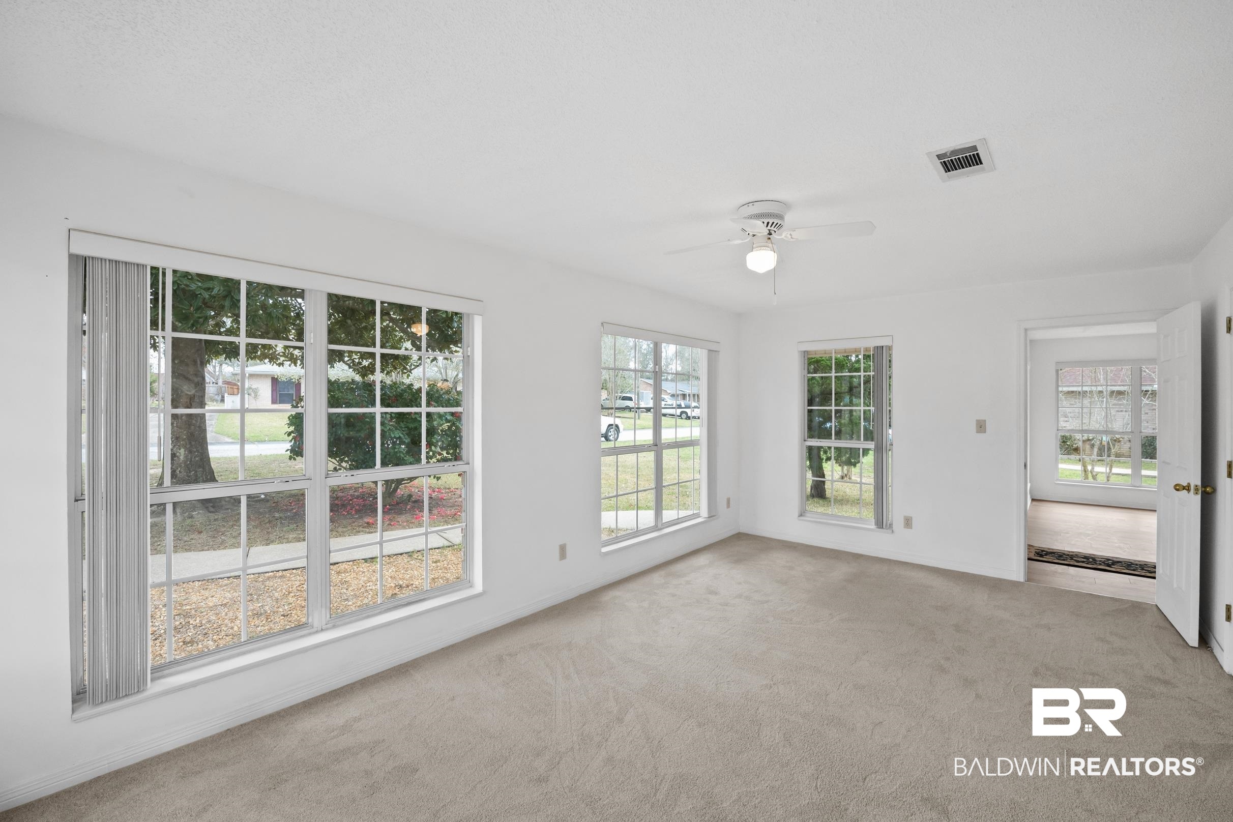 2673 Pine Ridge Drive Lillian, AL 36549 - Photo 21 of 38 Unfurnished sunroom with visible vents, plenty of natural light, and ceiling fan