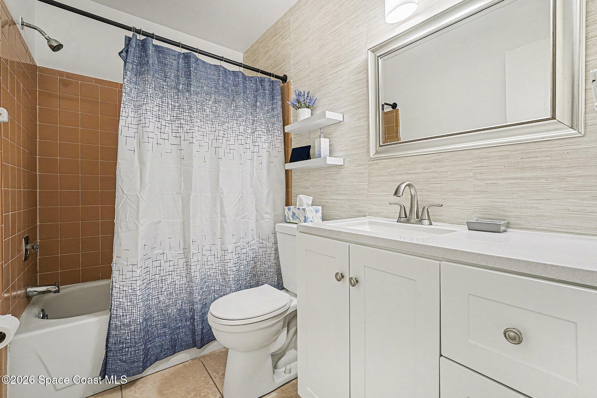 1491 Sheafe Avenue Northeast, Unit 104 Palm Bay, FL 32905 - Photo 12 of 19 a bathroom with a sink a toilet and shower
