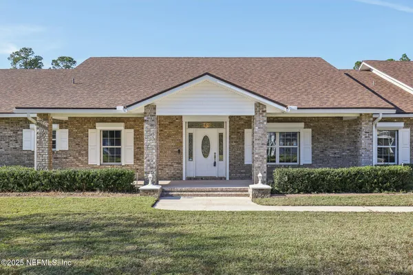 a view of kitchen with furniture and refrigerator