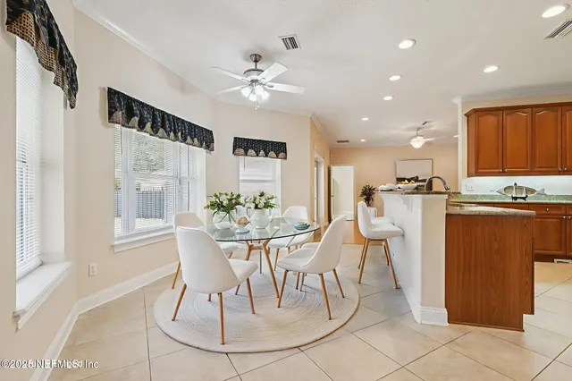 a view of an empty room with a window and a ceiling fan