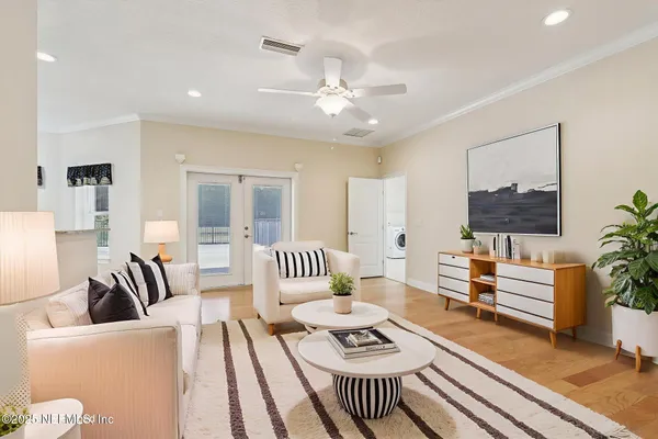 a spacious bedroom with a bed and a chandelier