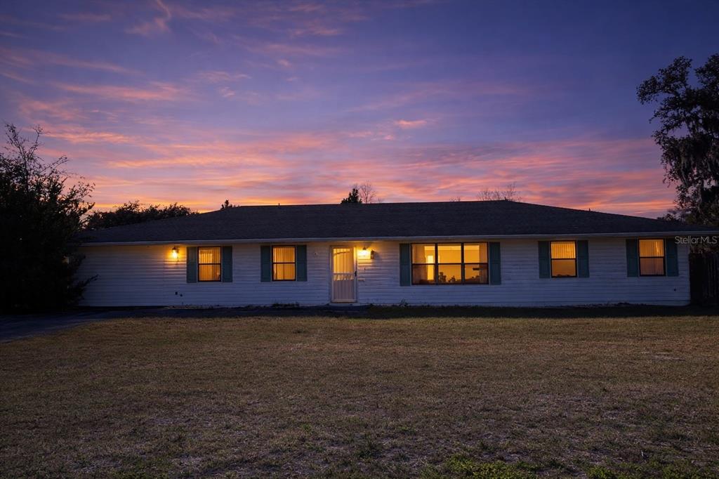 a front view of house with yard and trees