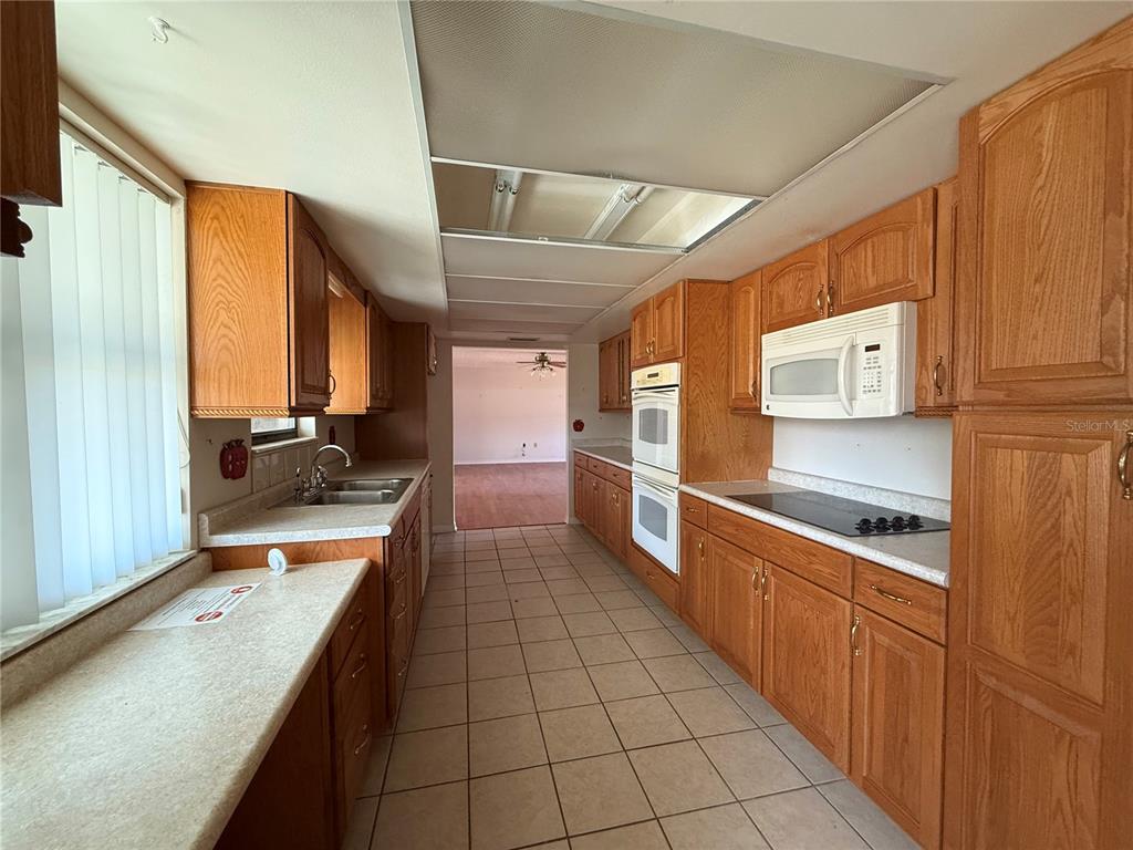 34847 Learn Road Leesburg, FL 34788 - Photo 11 of 25 a large kitchen with stainless steel appliances cabinets and a counter top space