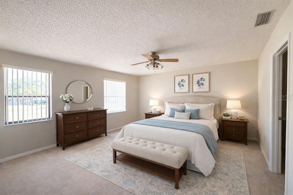 34847 Learn Road Leesburg, FL 34788 - Photo 12 of 25 a bedroom with a bed dresser and wooden floor