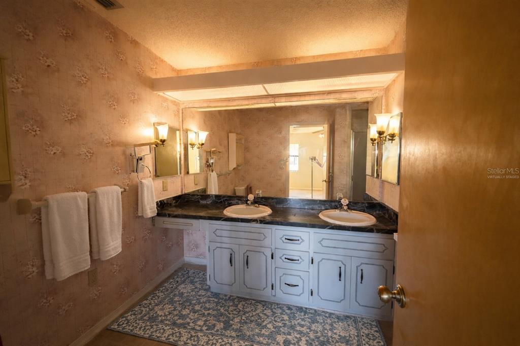 34847 Learn Road Leesburg, FL 34788 - Photo 14 of 25 a bathroom with a granite countertop sink and a mirror