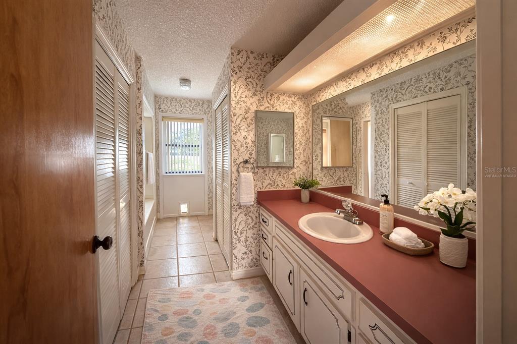 34847 Learn Road Leesburg, FL 34788 - Photo 20 of 25 a spacious bathroom with a granite countertop sink and a mirror