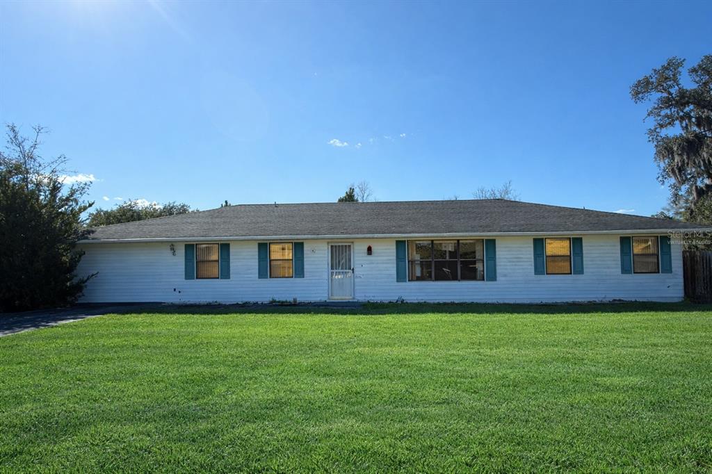 34847 Learn Road Leesburg, FL 34788 - Photo 2 of 25 a front view of a house with yard and green space