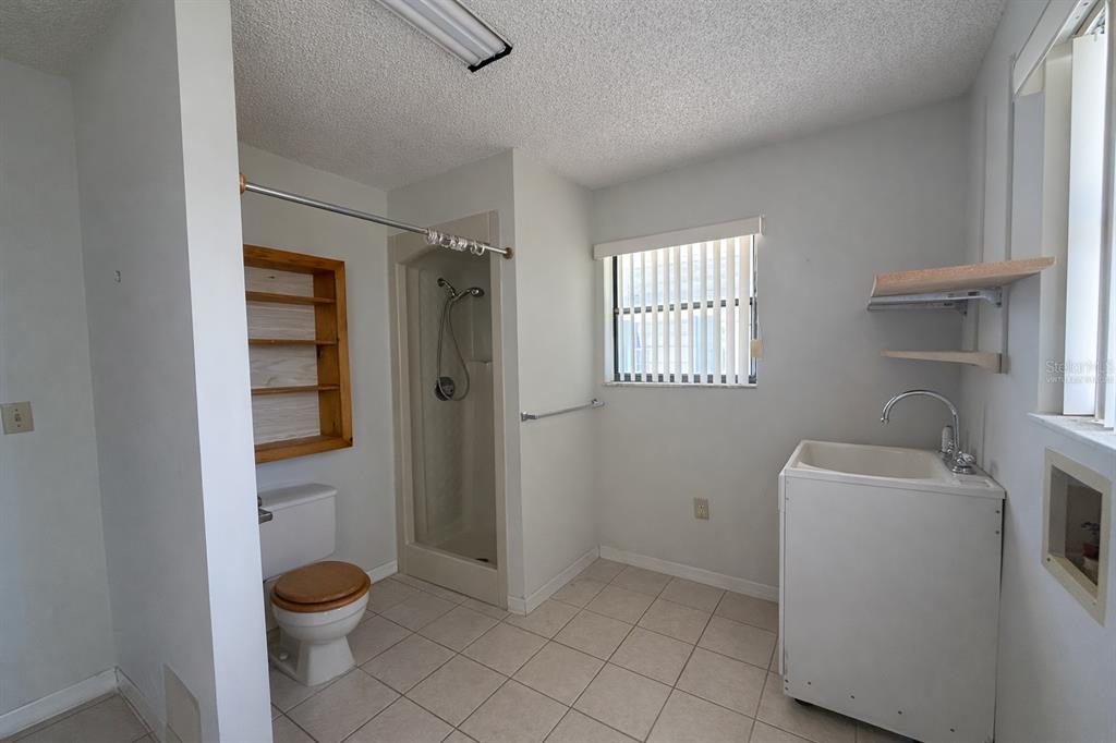 34847 Learn Road Leesburg, FL 34788 - Photo 22 of 25 a bathroom with a toilet sink and shower