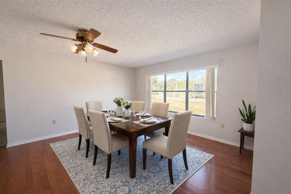 34847 Learn Road Leesburg, FL 34788 - Photo 6 of 25 a view of a dining room with furniture window and wooden floor