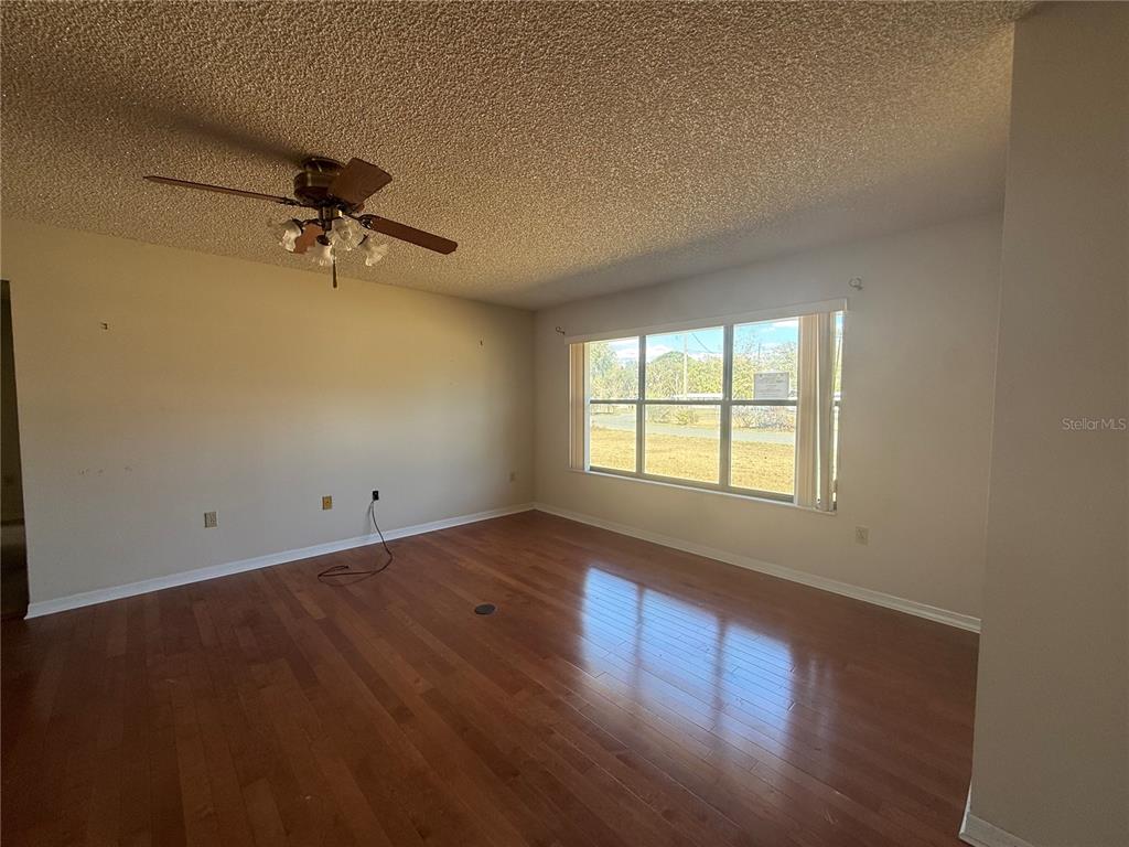 34847 Learn Road Leesburg, FL 34788 - Photo 7 of 25 wooden floor in an empty room with a window