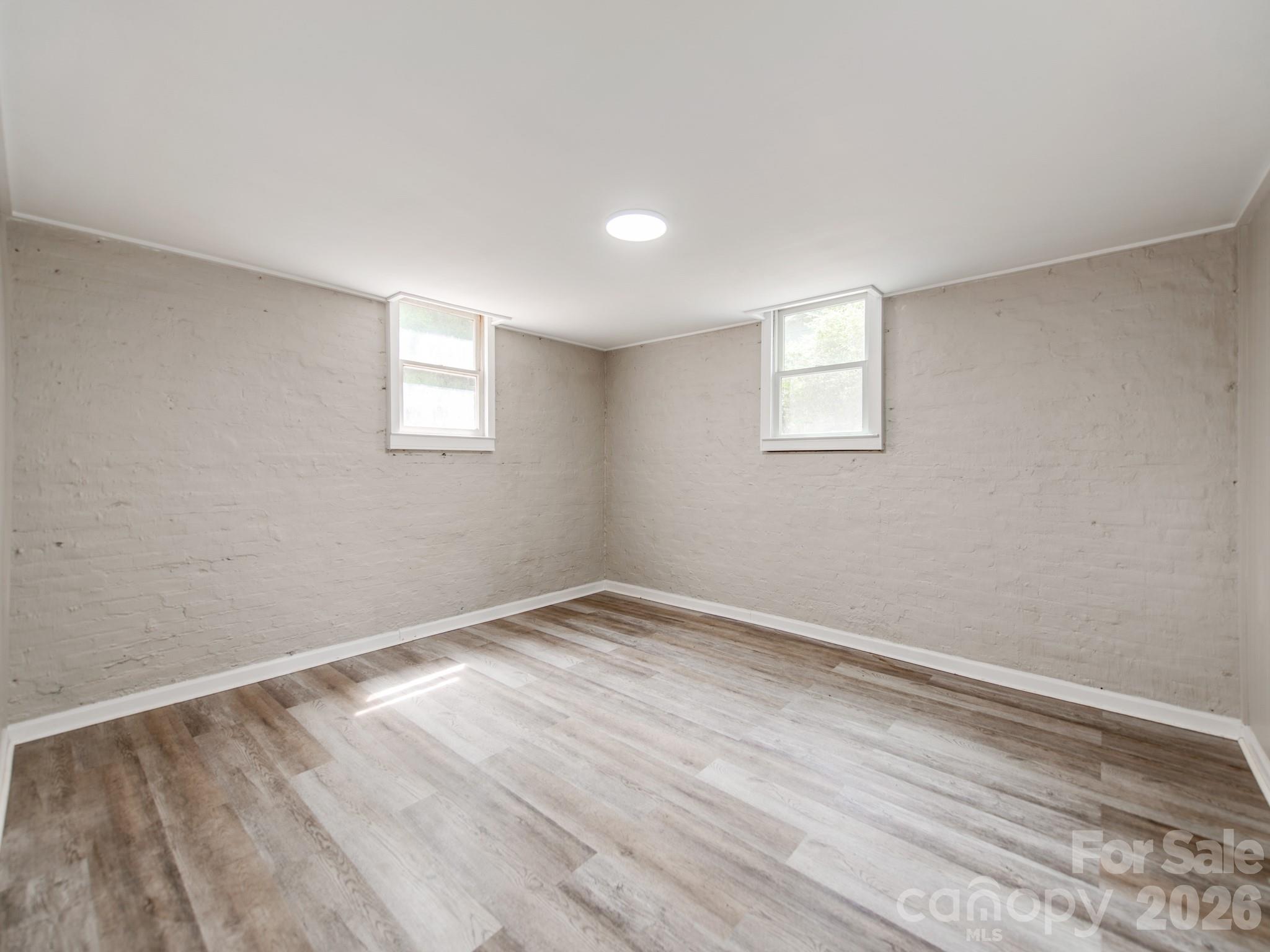 113 Falls Street Morganton, NC 28655 - Photo 25 of 33 a view of an empty room with wooden floor and a window