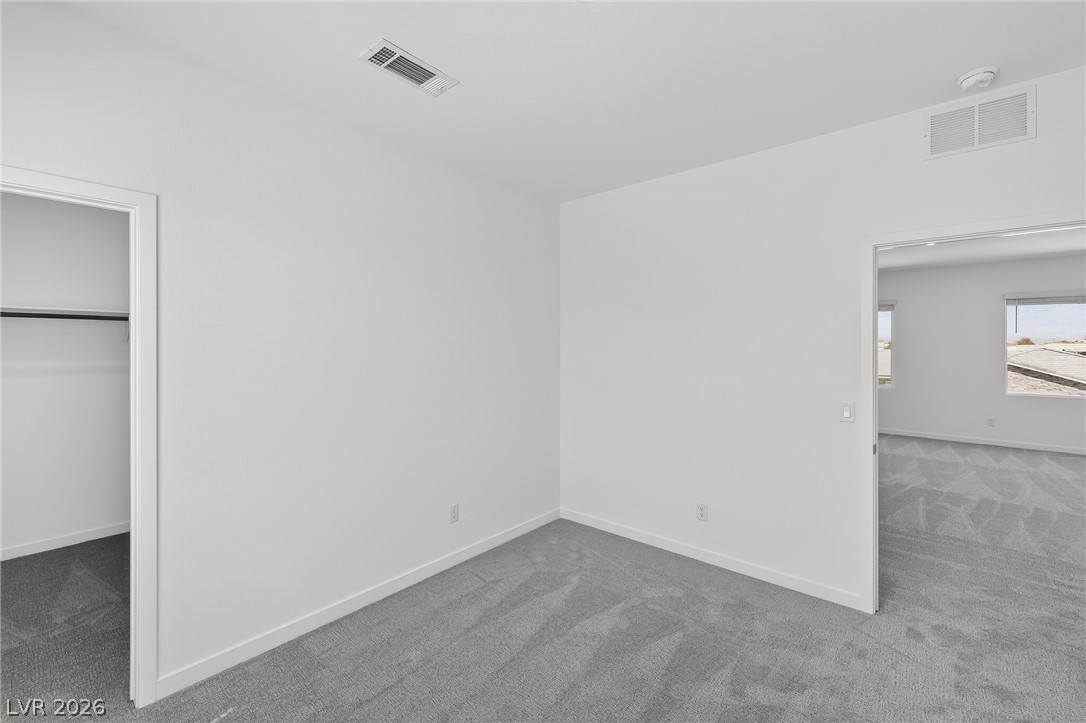 347 Sam Way Mesquite, NV 89027 - Photo 17 of 32 A spacious, naturally illuminated room featuring plush carpeting and a convenient walk-in closet.