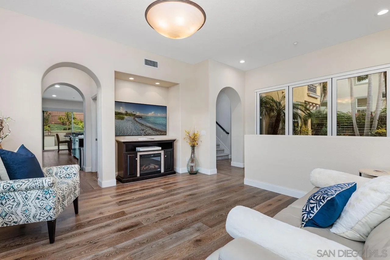 1460 Ravean Court Encinitas, CA 92024 - Photo 18 of 72 a living room with furniture a fireplace and a floor to ceiling window