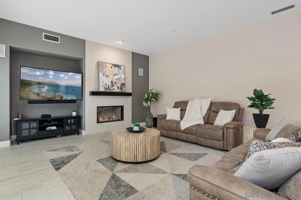 1460 Ravean Court Encinitas, CA 92024 - Photo 22 of 72 a living room with furniture a fireplace and a flat screen tv