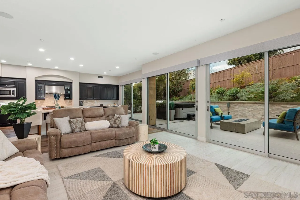 1460 Ravean Court Encinitas, CA 92024 - Photo 23 of 72 a living room with furniture and a floor to ceiling window