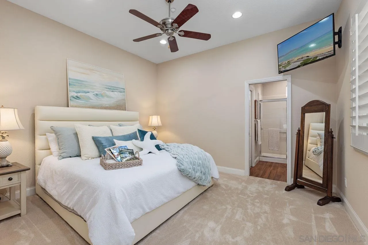 1460 Ravean Court Encinitas, CA 92024 - Photo 30 of 72 a bedroom with a bed and a chandelier