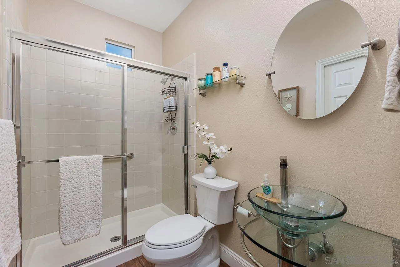 1460 Ravean Court Encinitas, CA 92024 - Photo 31 of 72 a bathroom with a toilet a sink and shower