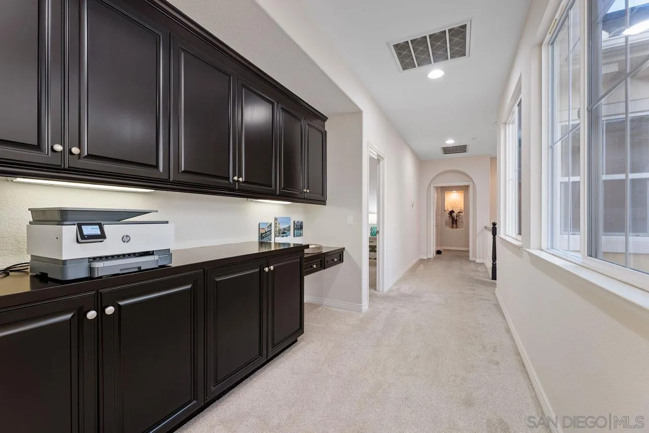 1460 Ravean Court Encinitas, CA 92024 - Photo 37 of 72 a kitchen with granite countertop stainless steel appliances and sink