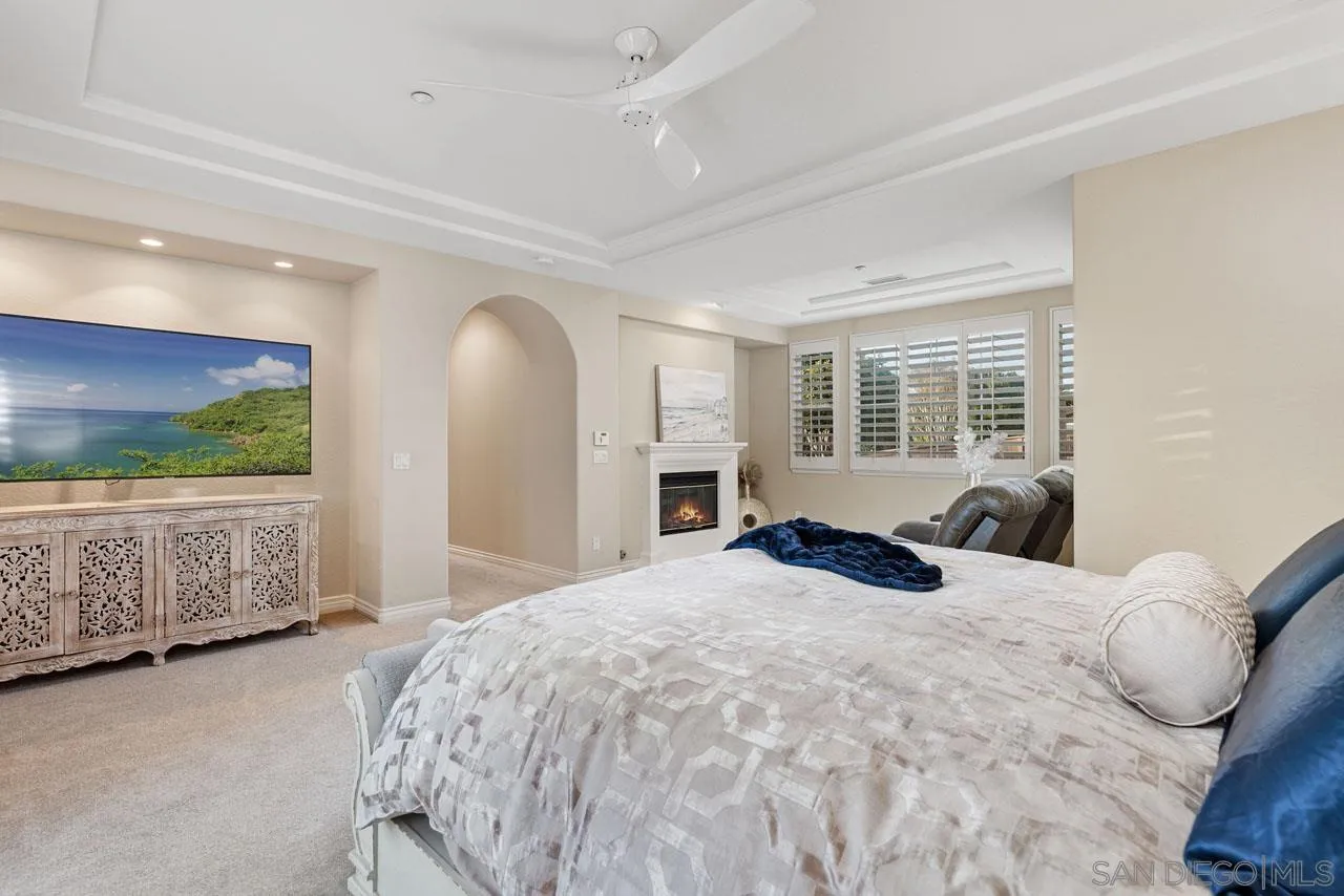 1460 Ravean Court Encinitas, CA 92024 - Photo 40 of 72 a large bed sitting in a bedroom next to a window