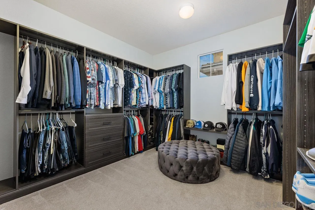 1460 Ravean Court Encinitas, CA 92024 - Photo 47 of 72 a walk in closet with clothes