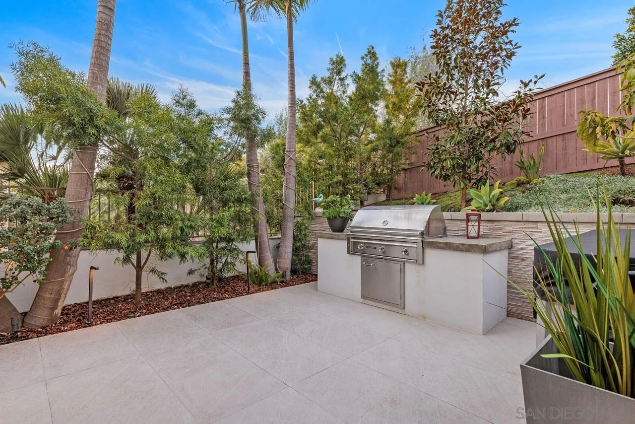 1460 Ravean Court Encinitas, CA 92024 - Photo 56 of 72 a backyard of a house with barbeque oven and outdoor seating