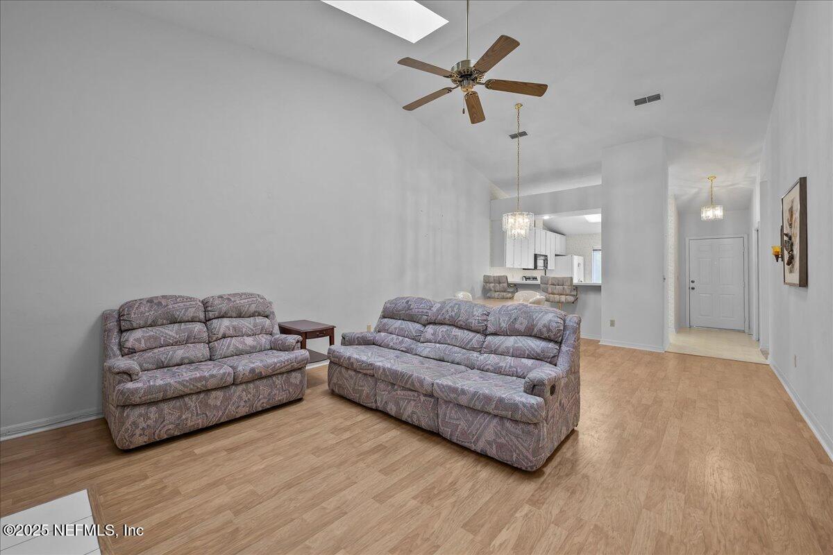 3726 Northwest 53rd Road Gainesville, FL 32653 - Photo 11 of 36 a living room with couches and a ceiling fan