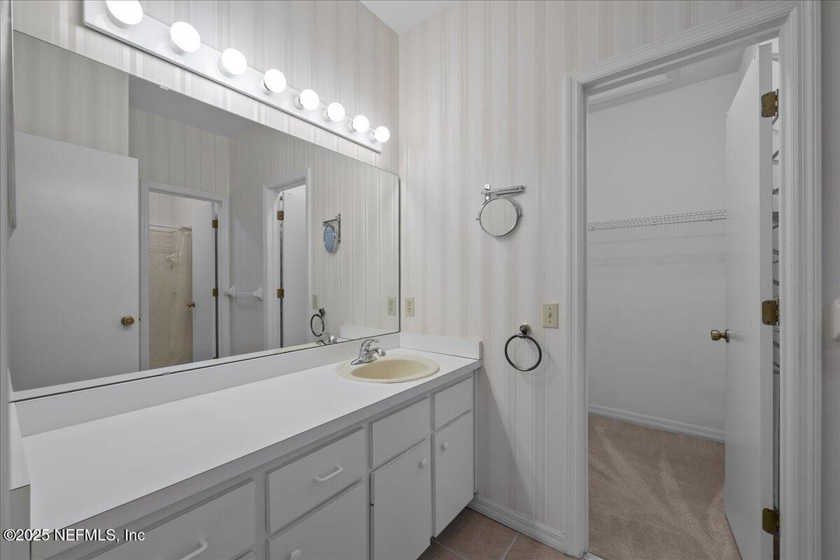 3726 Northwest 53rd Road Gainesville, FL 32653 - Photo 17 of 36 a bathroom with a double vanity sink and a mirror
