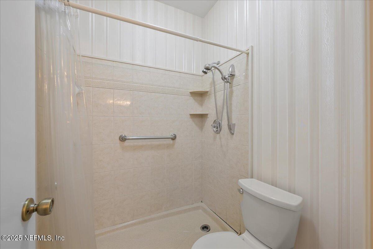 3726 Northwest 53rd Road Gainesville, FL 32653 - Photo 18 of 36 a bathroom with a shower and toilet