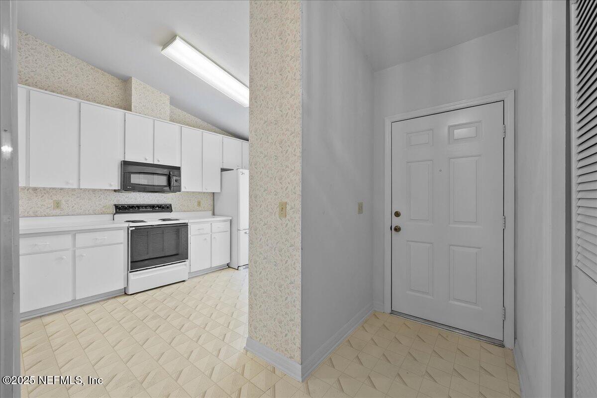 3726 Northwest 53rd Road Gainesville, FL 32653 - Photo 4 of 36 a kitchen with granite countertop white cabinets and stainless steel appliances