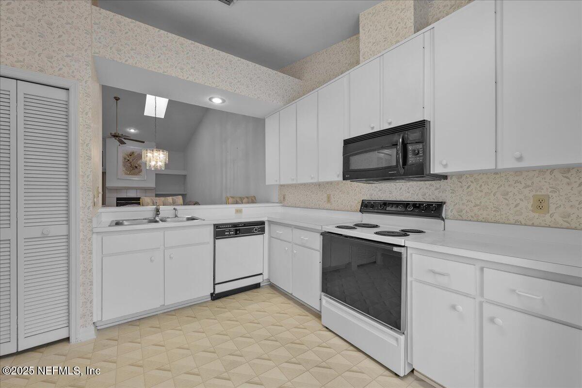 3726 Northwest 53rd Road Gainesville, FL 32653 - Photo 7 of 36 a kitchen with cabinets stainless steel appliances and sink