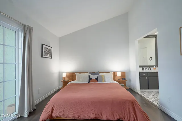 a bedroom with a bed and cabinets