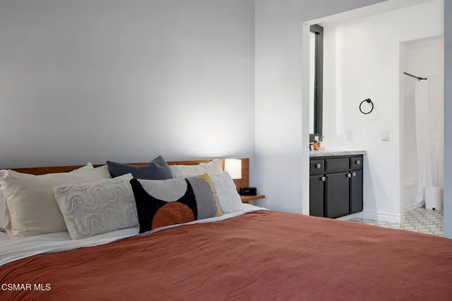 a bedroom with bed and window