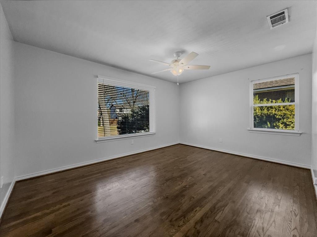 2709 Ripplewood Drive Dallas, TX 75228 - Photo 14 of 24 a view of an empty room with wooden floor and a window