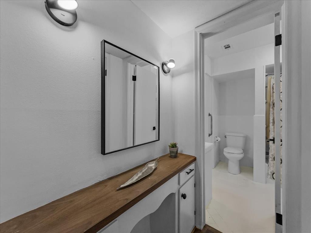 2709 Ripplewood Drive Dallas, TX 75228 - Photo 19 of 24 a view of a bathroom with a sink and a toilet