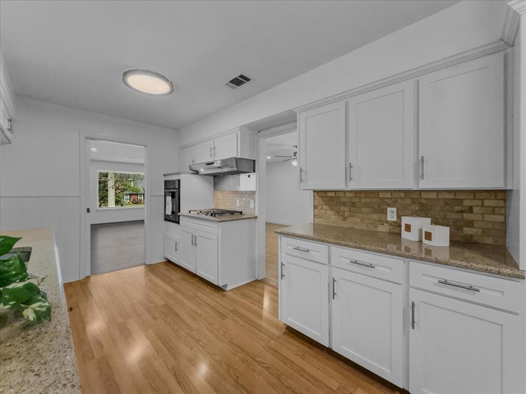 2709 Ripplewood Drive Dallas, TX 75228 - Photo 4 of 24 a kitchen with cabinets and wooden floor