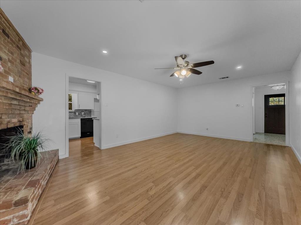 2709 Ripplewood Drive Dallas, TX 75228 - Photo 6 of 24 a view of an empty room with a ceiling fan and wooden floor