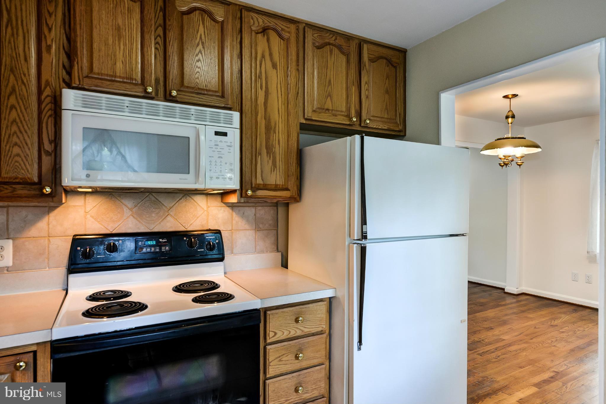 11809 Indigo Road Silver Spring, MD 20906 - Photo 13 of 30 a kitchen with a stove and a microwave