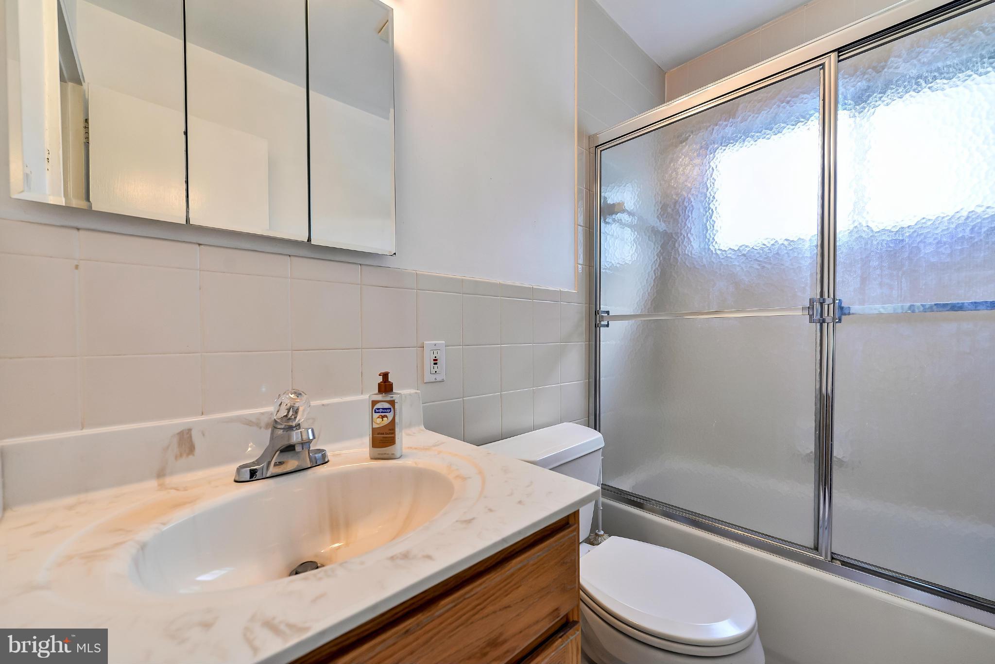 11809 Indigo Road Silver Spring, MD 20906 - Photo 16 of 30 a bathroom with a sink toilet and shower