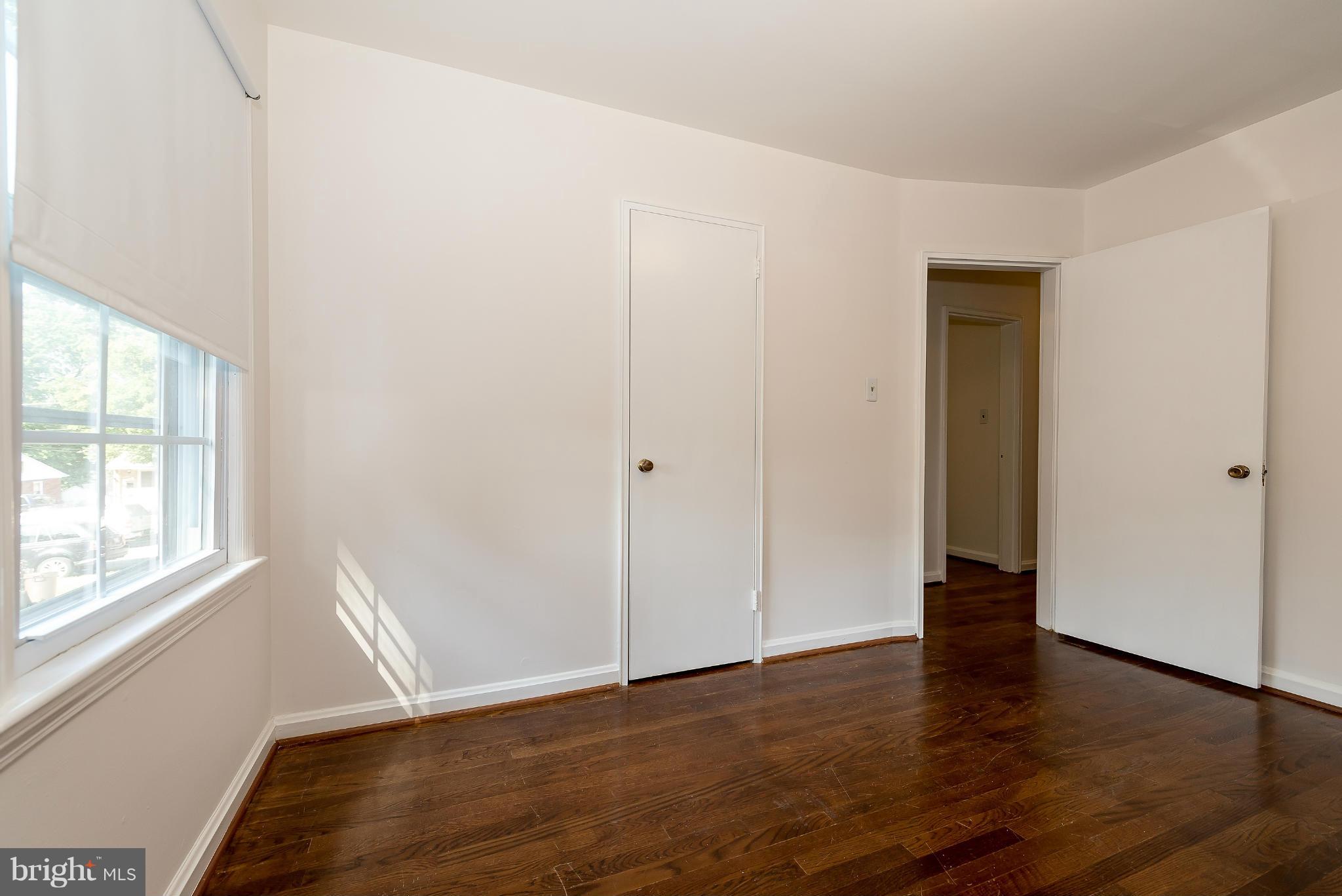 11809 Indigo Road Silver Spring, MD 20906 - Photo 21 of 30 an empty room with wooden floor and windows