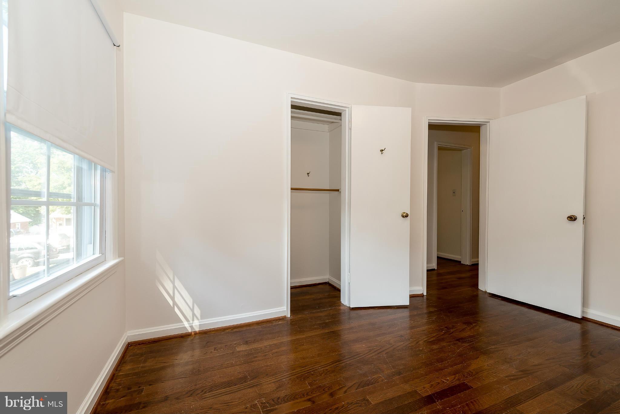 11809 Indigo Road Silver Spring, MD 20906 - Photo 22 of 30 an empty room with wooden floor and windows
