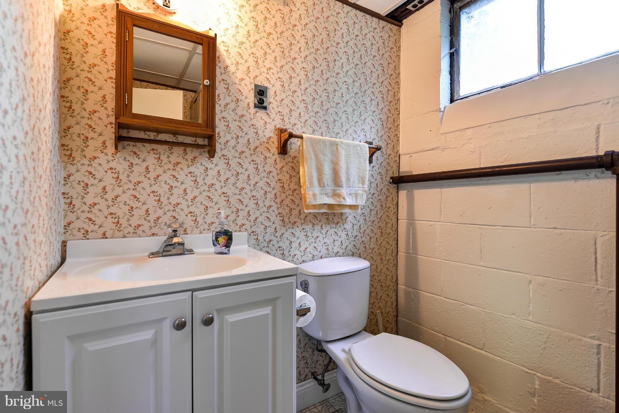 11809 Indigo Road Silver Spring, MD 20906 - Photo 26 of 30 a bathroom with a sink a toilet and mirror