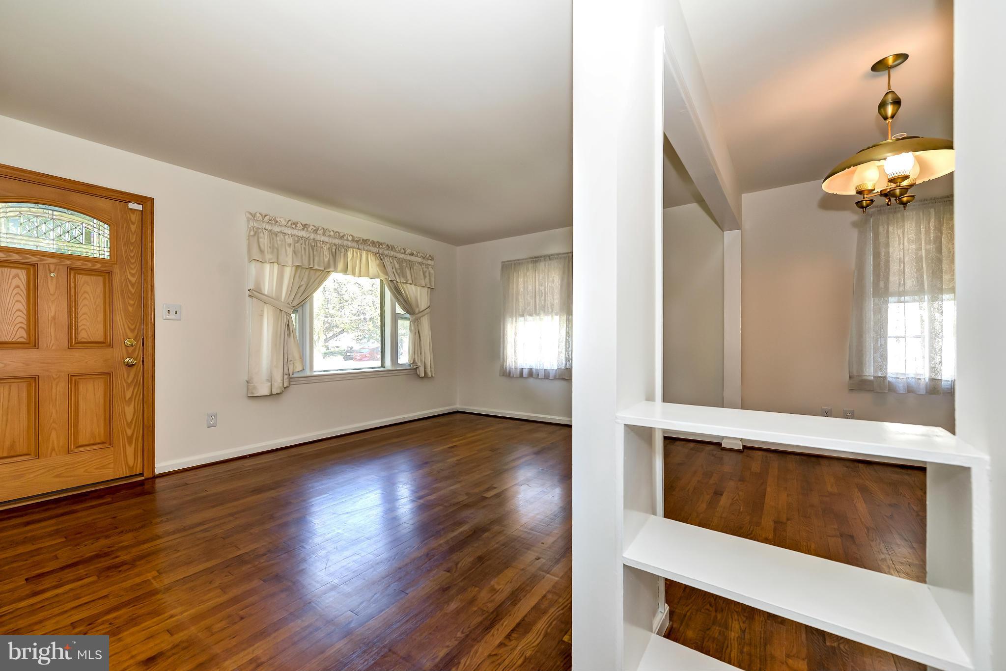 11809 Indigo Road Silver Spring, MD 20906 - Photo 4 of 30 a view of an empty room with wooden floor and a window