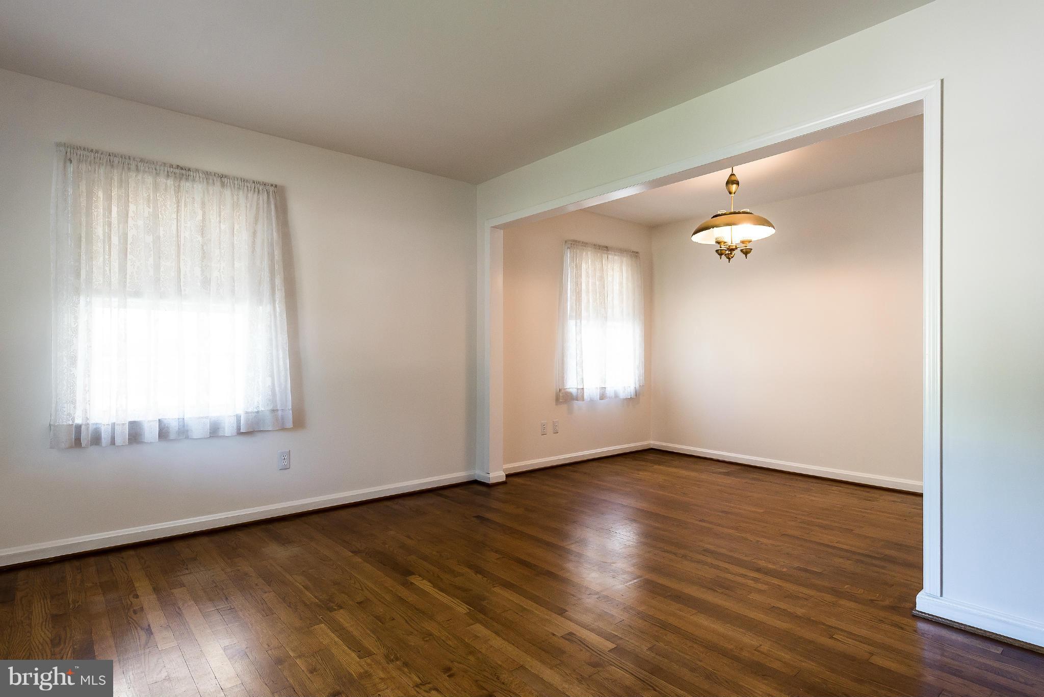 11809 Indigo Road Silver Spring, MD 20906 - Photo 6 of 30 an empty room with wooden floor and windows